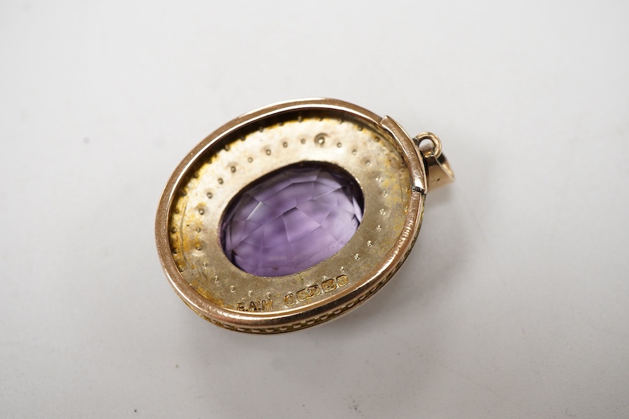 An Edwardian 9ct gold, amethyst and seed pearl cluster set oval pendant, Edwin Alfred Marsh, Birmingham, 1903, overall 35mm.